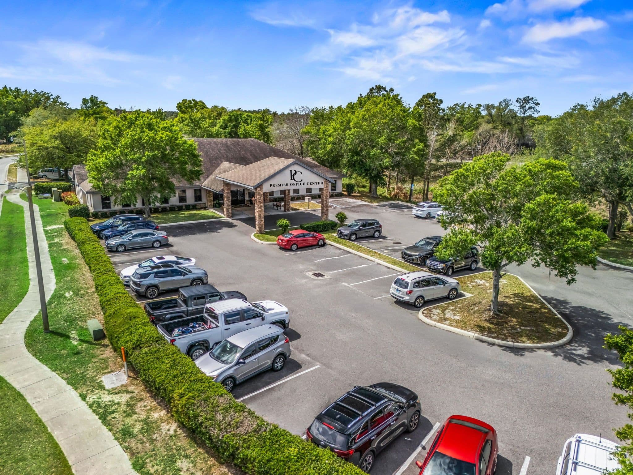 A view of the resort's parking lot by the lake, featuring parked cars and surrounding greenery.