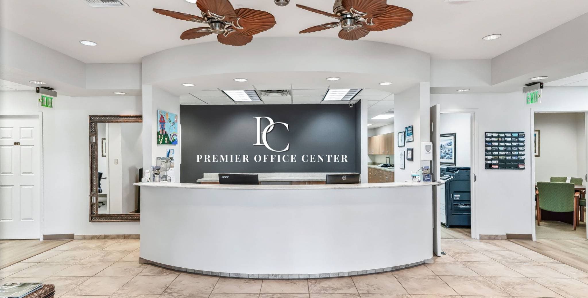 A modern office lobby featuring a curved white reception desk with 