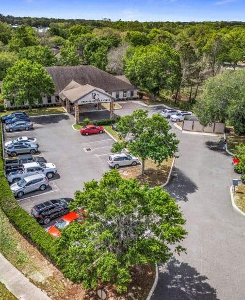 Aerial view of a parking lot with several cars and a building labeled 